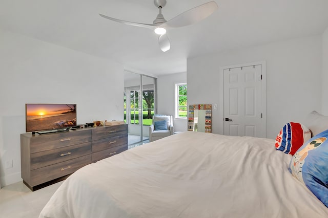 bedroom with access to outside and ceiling fan