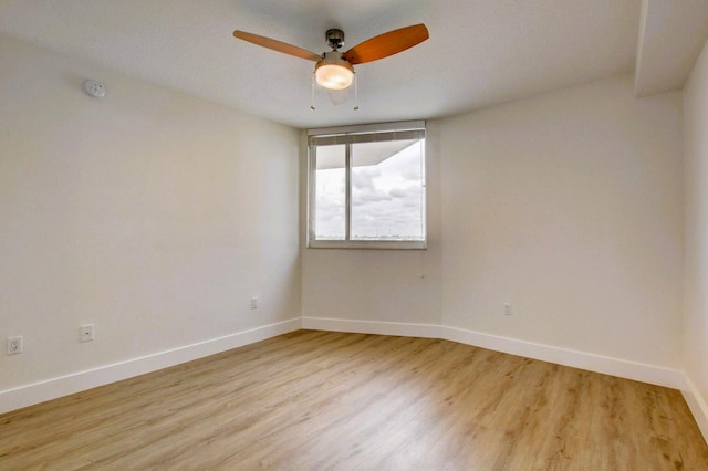 spare room featuring ceiling fan and light hardwood / wood-style flooring