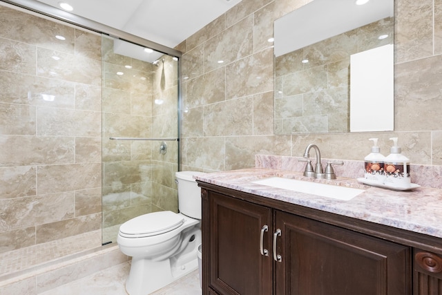 bathroom with toilet, vanity, tile walls, and an enclosed shower