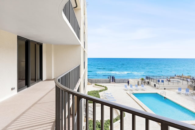 balcony featuring a water view and a patio