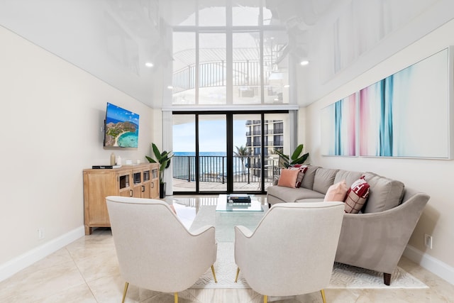 tiled living room with a towering ceiling