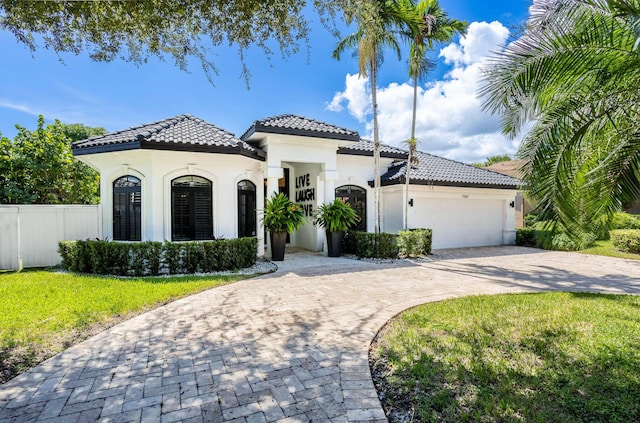 mediterranean / spanish-style house with a front lawn and a garage