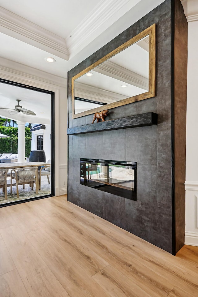 unfurnished living room featuring crown molding, ceiling fan, and wood-type flooring