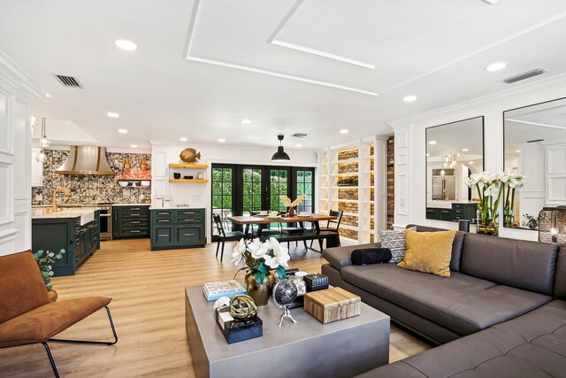 living room featuring light hardwood / wood-style floors and ornamental molding