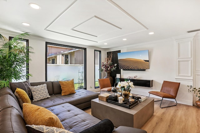 living room featuring light hardwood / wood-style flooring and ornamental molding