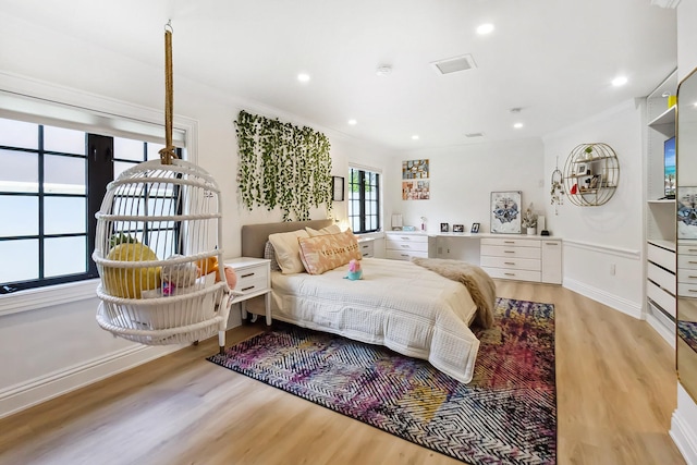 bedroom with light wood-type flooring and crown molding