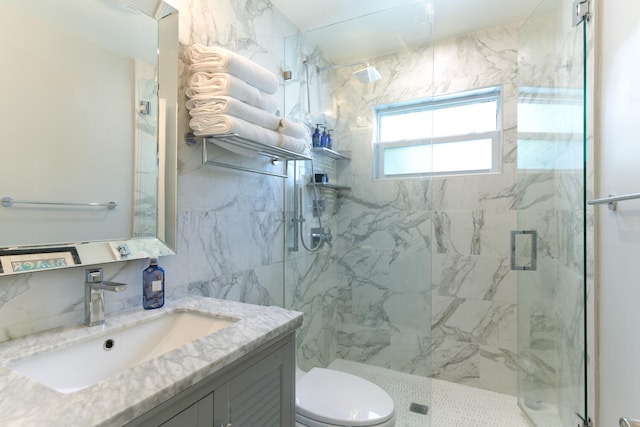 bathroom with vanity, toilet, and a shower with shower door