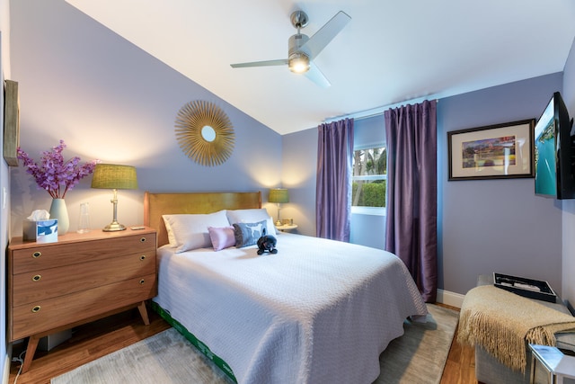 bedroom featuring ceiling fan, vaulted ceiling, and wood-type flooring