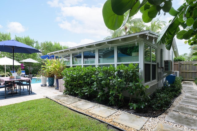 view of side of property featuring a patio area