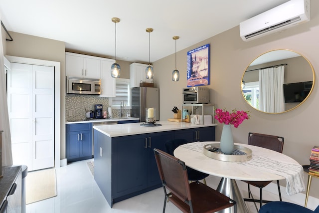 kitchen with blue cabinets, white cabinets, hanging light fixtures, stainless steel appliances, and a wall unit AC