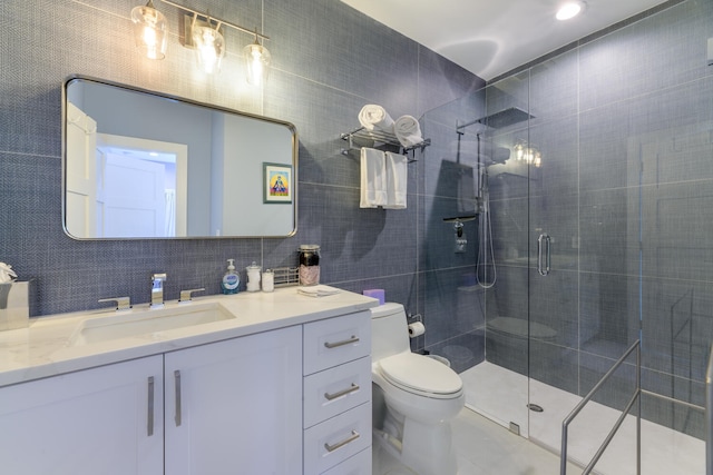 bathroom featuring vanity, tasteful backsplash, tile walls, toilet, and a shower with door