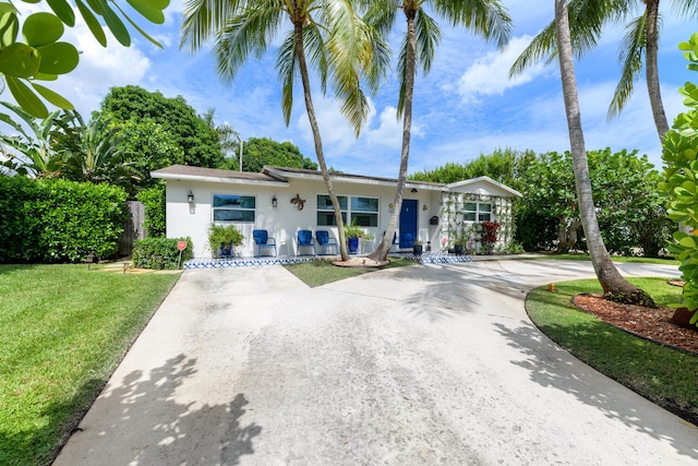 ranch-style home with a front lawn