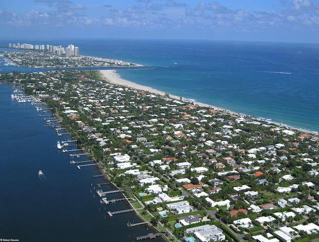 birds eye view of property featuring a beach view and a water view