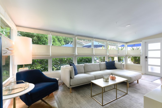 sunroom / solarium featuring vaulted ceiling and a healthy amount of sunlight