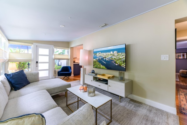 living room with lofted ceiling and hardwood / wood-style flooring