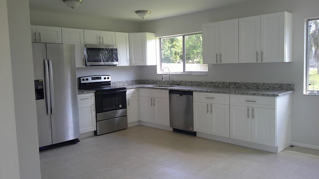 kitchen featuring stainless steel appliances, sink, and a wealth of natural light