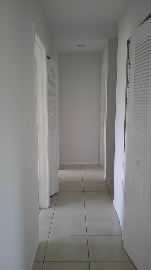 corridor with light tile patterned floors