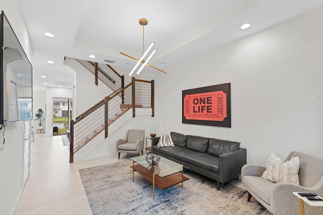 living room with light hardwood / wood-style floors and a chandelier