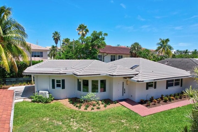 exterior space with a lawn and ac unit