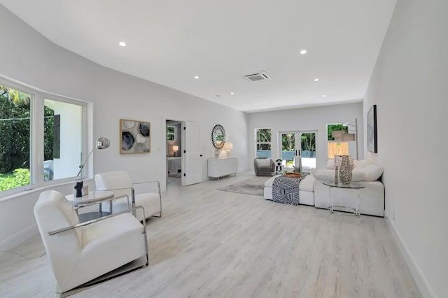 living room with light wood-type flooring and french doors