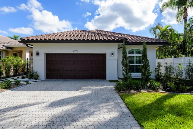 mediterranean / spanish home featuring a garage