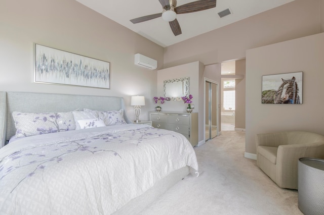 carpeted bedroom with ensuite bath, ceiling fan, a wall unit AC, and a closet