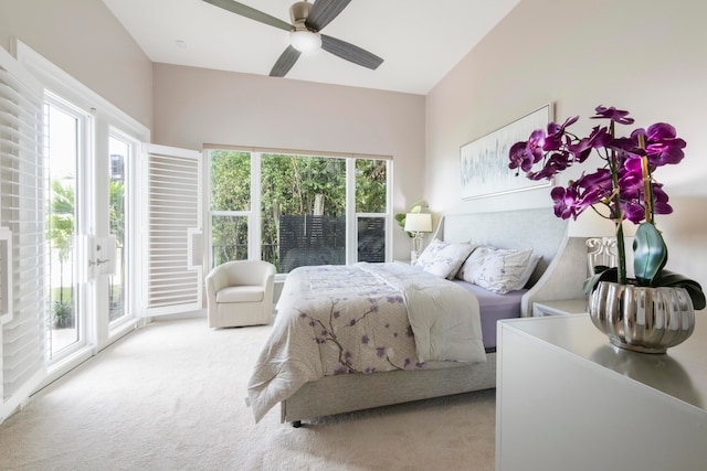 carpeted bedroom with ceiling fan, access to exterior, and multiple windows