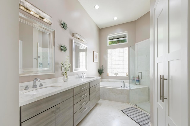 bathroom featuring vanity, plus walk in shower, and tile patterned floors