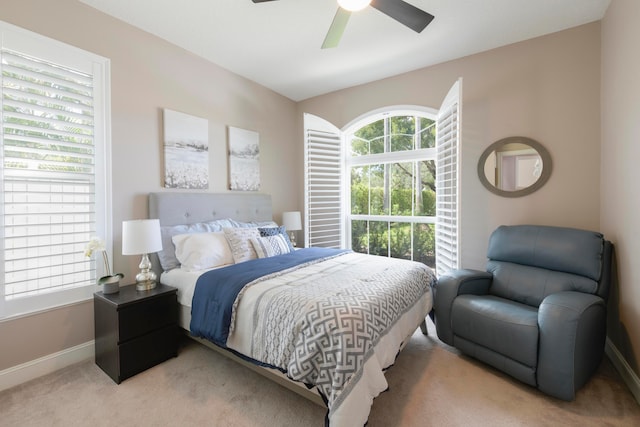 bedroom with ceiling fan and light colored carpet