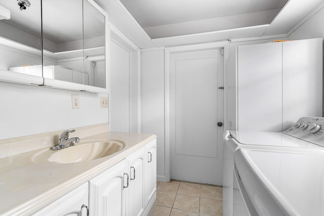 laundry area with separate washer and dryer, light tile patterned flooring, and sink