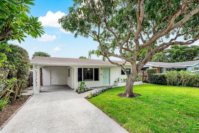 ranch-style home featuring a carport and a front yard