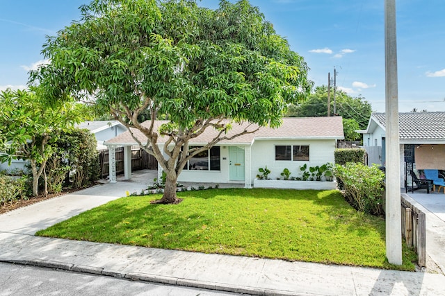 ranch-style home with a front lawn