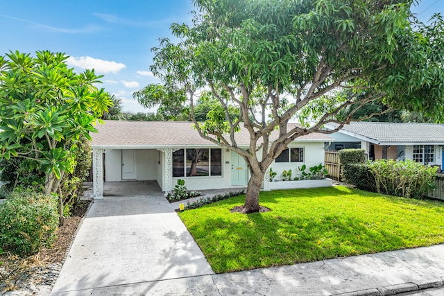 single story home with a front yard and a carport