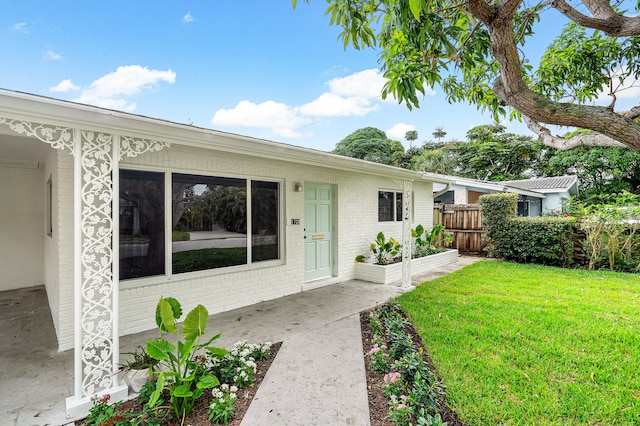 exterior space with a patio and a front lawn