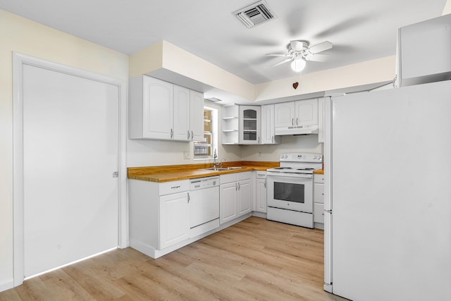 kitchen featuring white cabinets, wooden counters, white appliances, and light hardwood / wood-style flooring