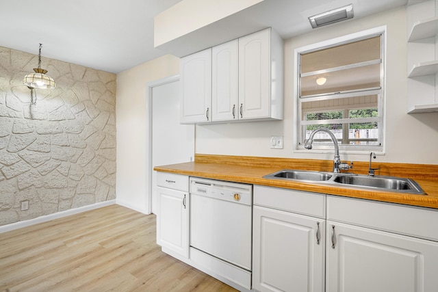 kitchen with light wood-type flooring, sink, white cabinetry, decorative light fixtures, and white dishwasher