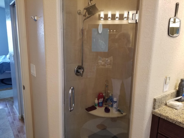 bathroom featuring vanity, tile patterned flooring, and an enclosed shower