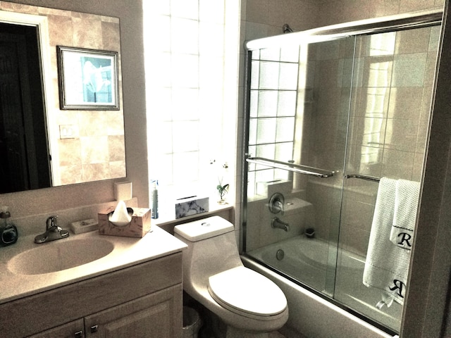 full bathroom with shower / bath combination with glass door, vanity, and toilet