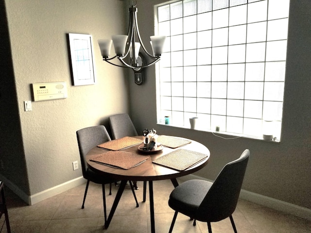 dining room with a notable chandelier and light tile patterned floors