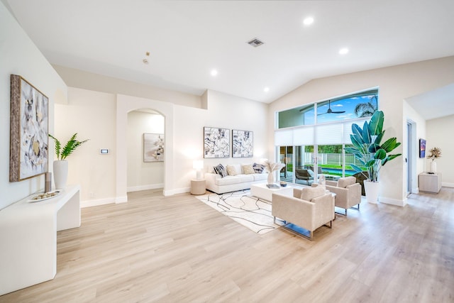 living room with vaulted ceiling and light hardwood / wood-style flooring