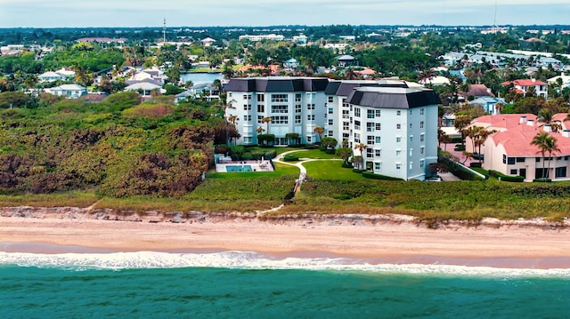 birds eye view of property with a view of the beach and a water view