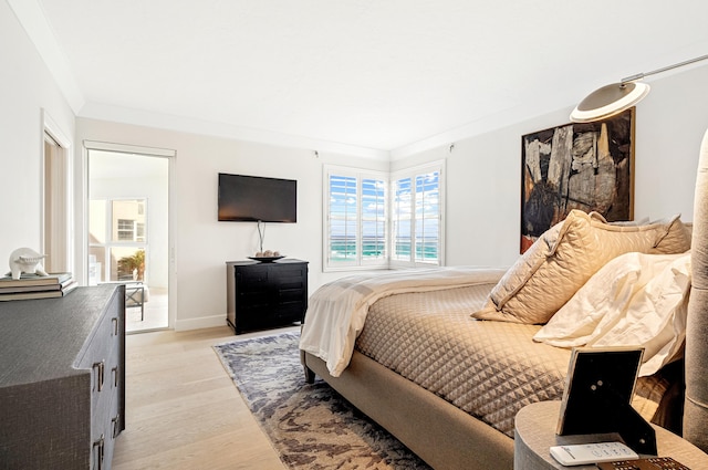 bedroom with light hardwood / wood-style flooring and crown molding