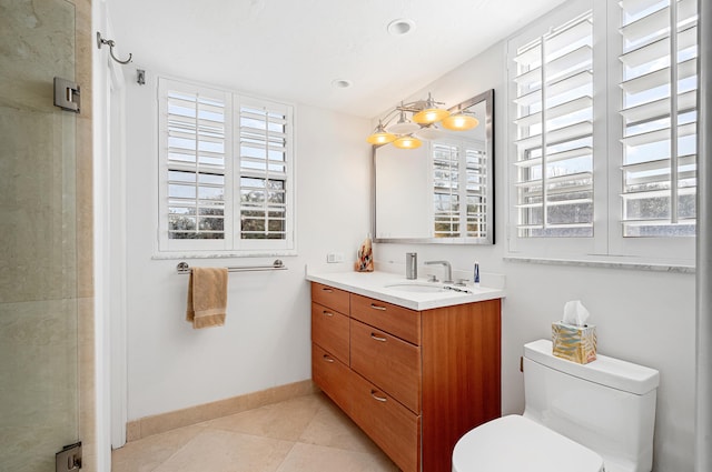 bathroom featuring tile patterned flooring, walk in shower, vanity, and toilet