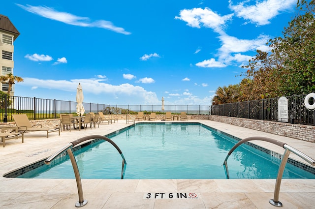 view of swimming pool featuring a patio area