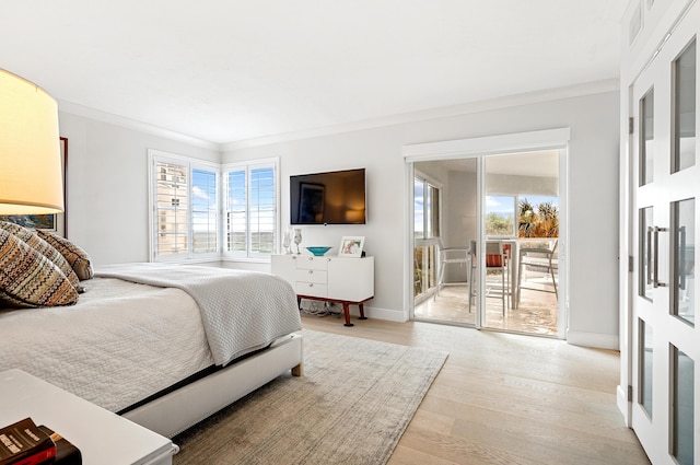 bedroom with light hardwood / wood-style flooring, access to outside, and ornamental molding