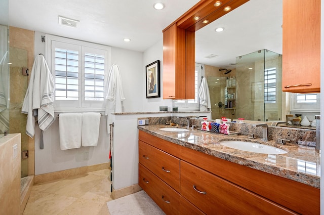 bathroom featuring vanity, tile patterned flooring, and a shower with door