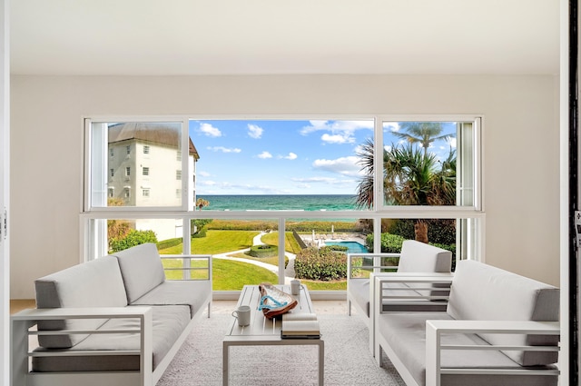 sunroom with a water view and a healthy amount of sunlight