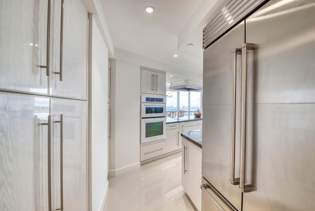 kitchen featuring double oven and high quality fridge