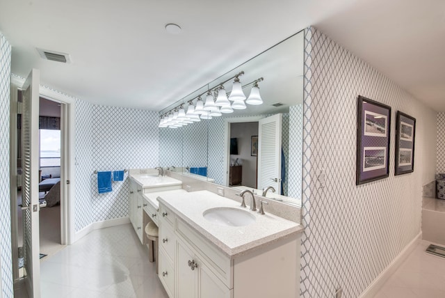 bathroom with tile patterned floors and vanity