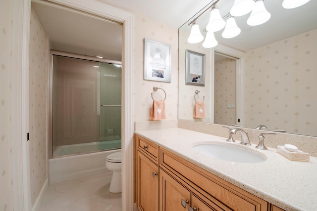 full bathroom featuring tile patterned flooring, a notable chandelier, vanity, enclosed tub / shower combo, and toilet